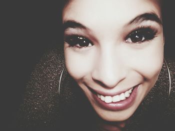 Close-up portrait of a smiling young woman