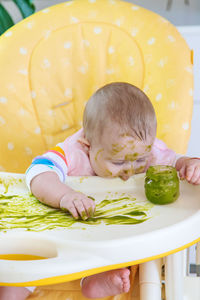 High angle view of cute baby boy lying on table