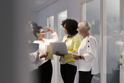 Coworkers talking in corridor