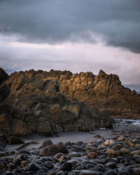 Rocks in sea against sky