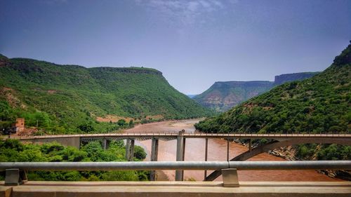 Arch bridge over river against sky
