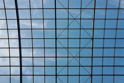 Low angle view of modern building against blue sky