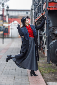 Low section of woman standing in city