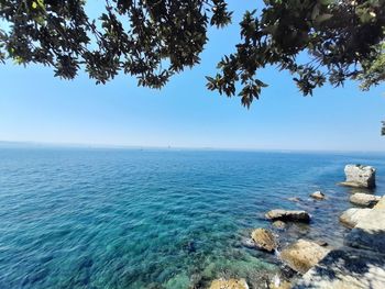 Scenic view of sea against blue sky