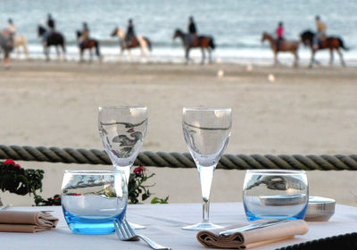 Close-up of drink on table at beach