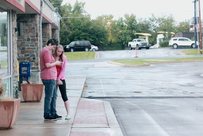 Couple standing outside house