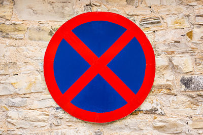 Close-up of arrow sign on wall