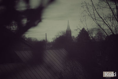 Panoramic view of trees and buildings against sky