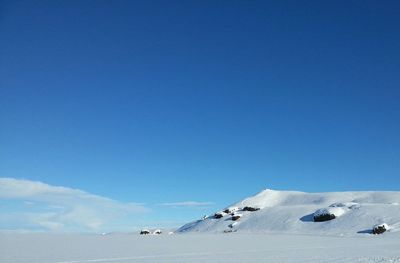 Scenic view of snow covered field against sky