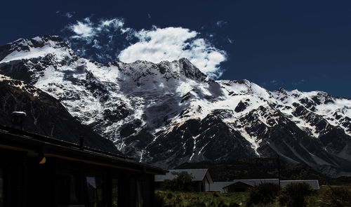 Low angle view of snowcapped mountains against sky