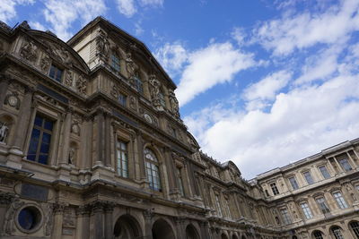 Low angle view of historical building against cloudy sky