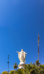 Low angle view of statue against clear blue sky