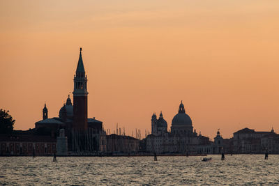 Sea in front of san giorgio maggiore church against sky during sunset