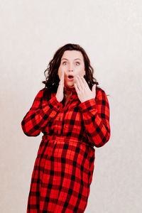 Portrait of beautiful young woman against white background