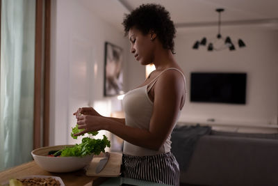 African american woman cooking healthy salad