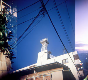 Low angle view of buildings against clear blue sky