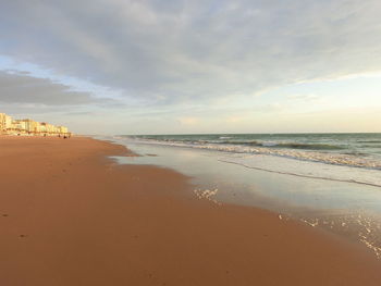 View of beach against cloudy sky