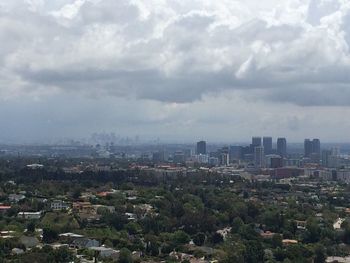 Cityscape against cloudy sky