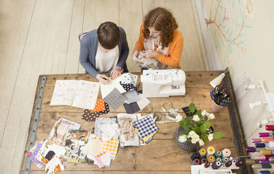 Two female fashion designers working together at their studio