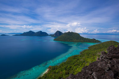 Scenic view of sea and mountains against sky