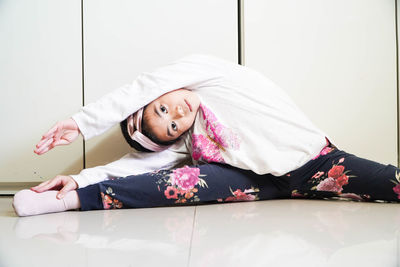 Portrait of young woman lying on bed