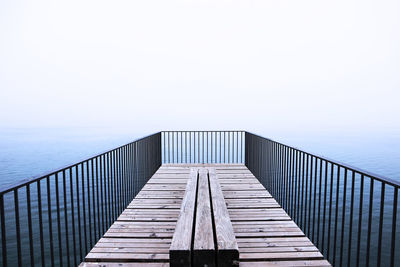 View of pier on sea against clear sky