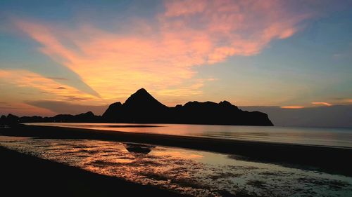 Scenic view of sea against romantic sky at sunset