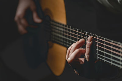 Close-up of man playing guitar