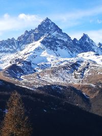 Scenic view of snowcapped mountains against sky