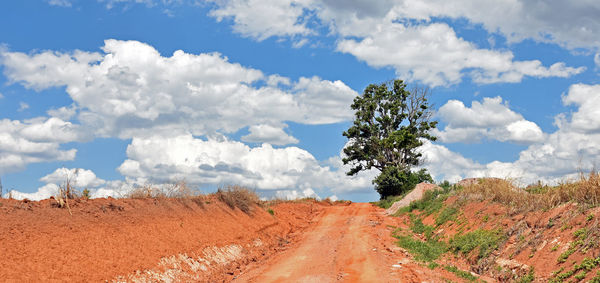 Panoramic view of dirt road against sky