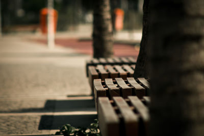 Empty bench by footpath