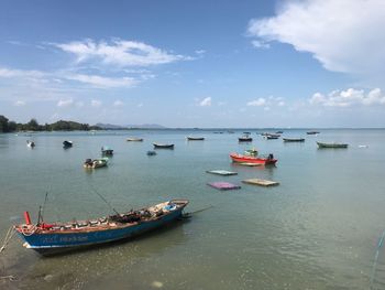 Boats in sea against sky