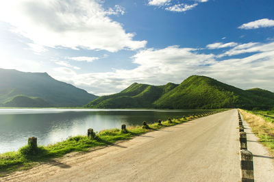 Scenic view of lake by mountains against sky