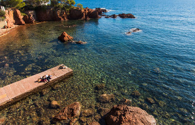 High angle view of rocks on sea