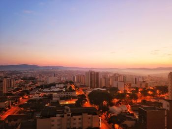 High angle view of buildings against sky during sunset