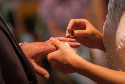 Midsection of couple holding hands