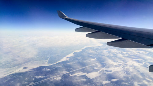 Aerial view of cloudscape over airplane wing