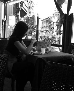 Woman sitting in front of building