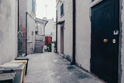 Empty alley amidst buildings in city