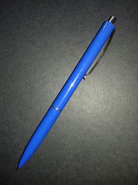 Close-up of pen over black background