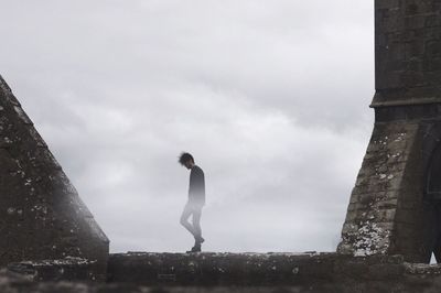 Low angle view of men against sky