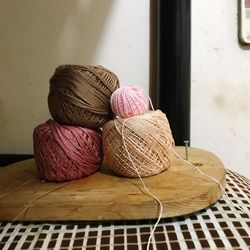 Close-up of wool on wooden board over bed