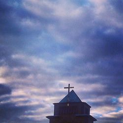 Low angle view of building against cloudy sky