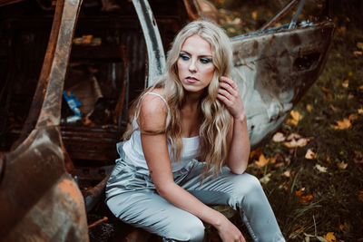 Portrait of young woman sitting outdoors