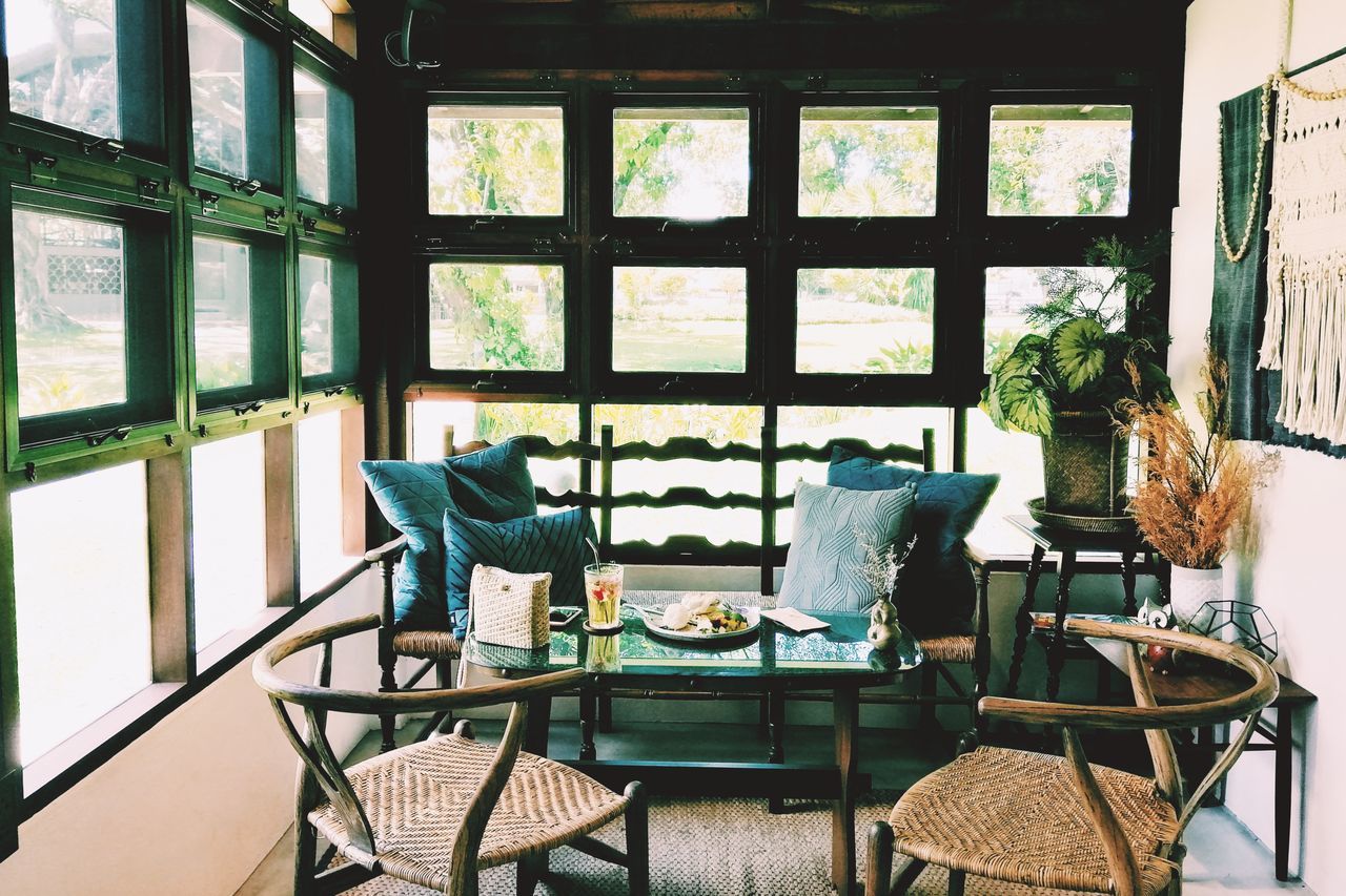 chair, seat, table, window, absence, furniture, no people, indoors, day, empty, architecture, business, glass - material, transparent, restaurant, wall, relaxation, arrangement, domestic room, setting, coffee table