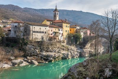 Bridge over river by buildings in town