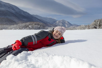 Young girl is having winter fun on a snowy, sunny day in lika, croatia