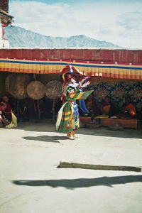 Full length of woman standing against sky