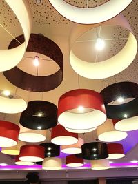 Low angle view of illuminated lighting equipment hanging on ceiling