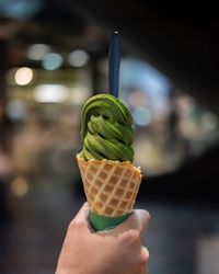 Close-up of hand holding ice cream cone